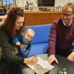 Liv Stråman med sonen Gunnar skriver under köpekontraktet till Kulturhuset tillsammans med Tomas Egmark, kommunstyrelsens ordförande. Foto: Peter Lundberg